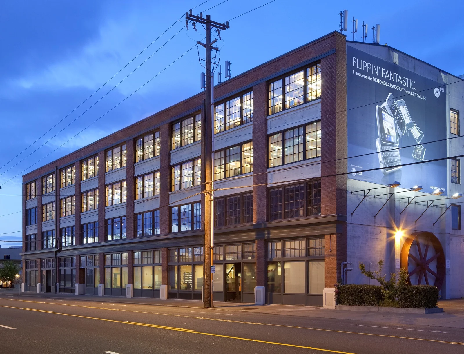 Multi-story brick building at 2200 First Avenue South in Seattle with large industrial windows at dusk